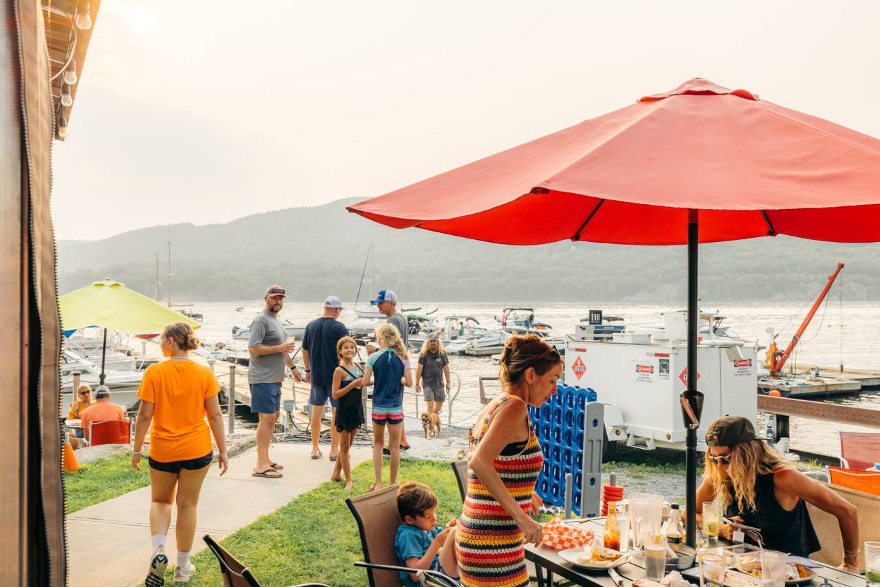 People enjoying lounging and lunch lakeside at Indian Bay Marina