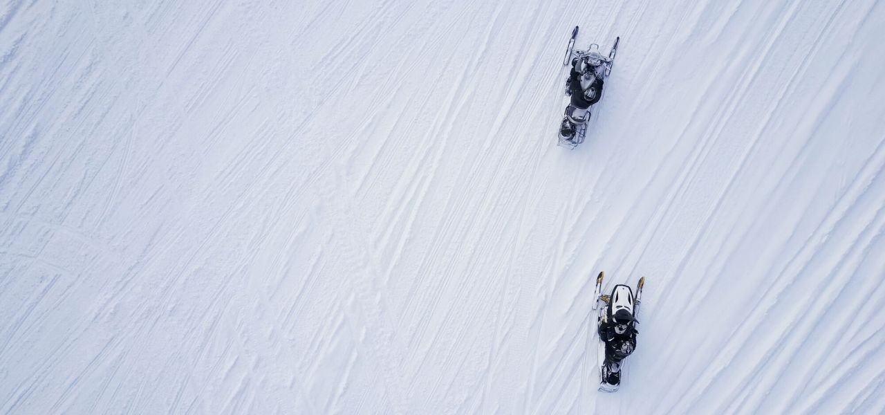 An aerial view of snowmobilers.