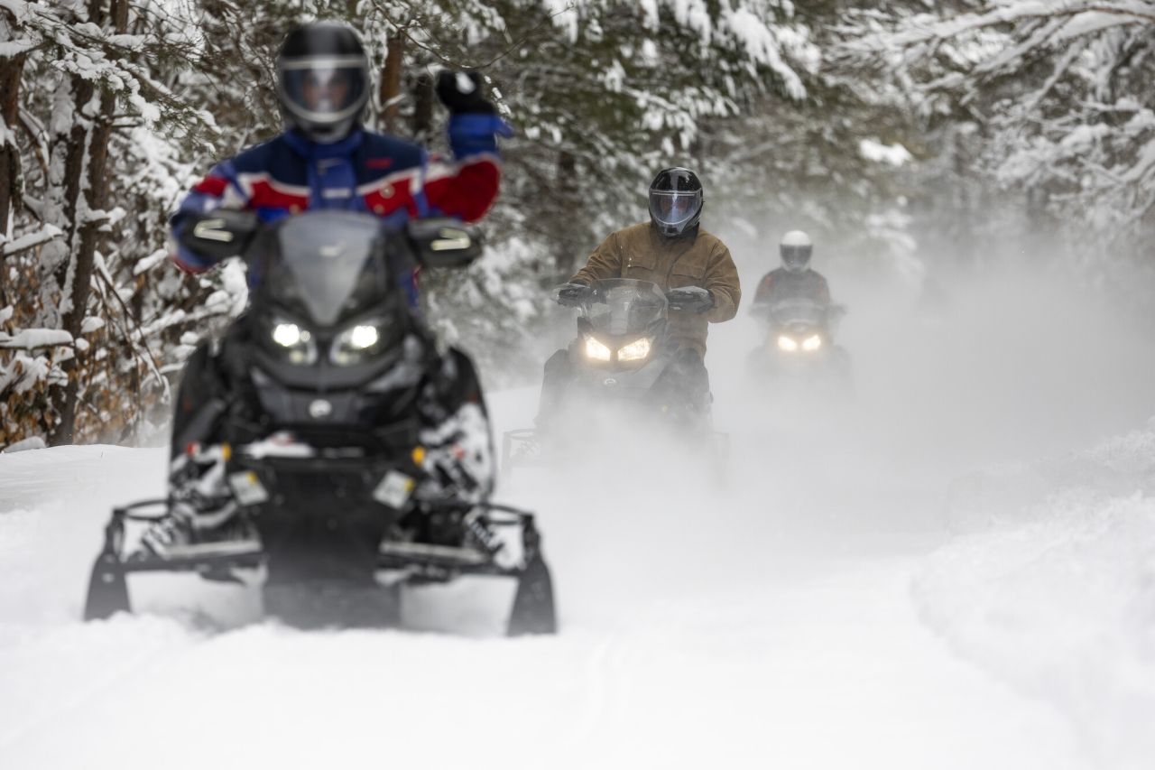 People snowmobiling