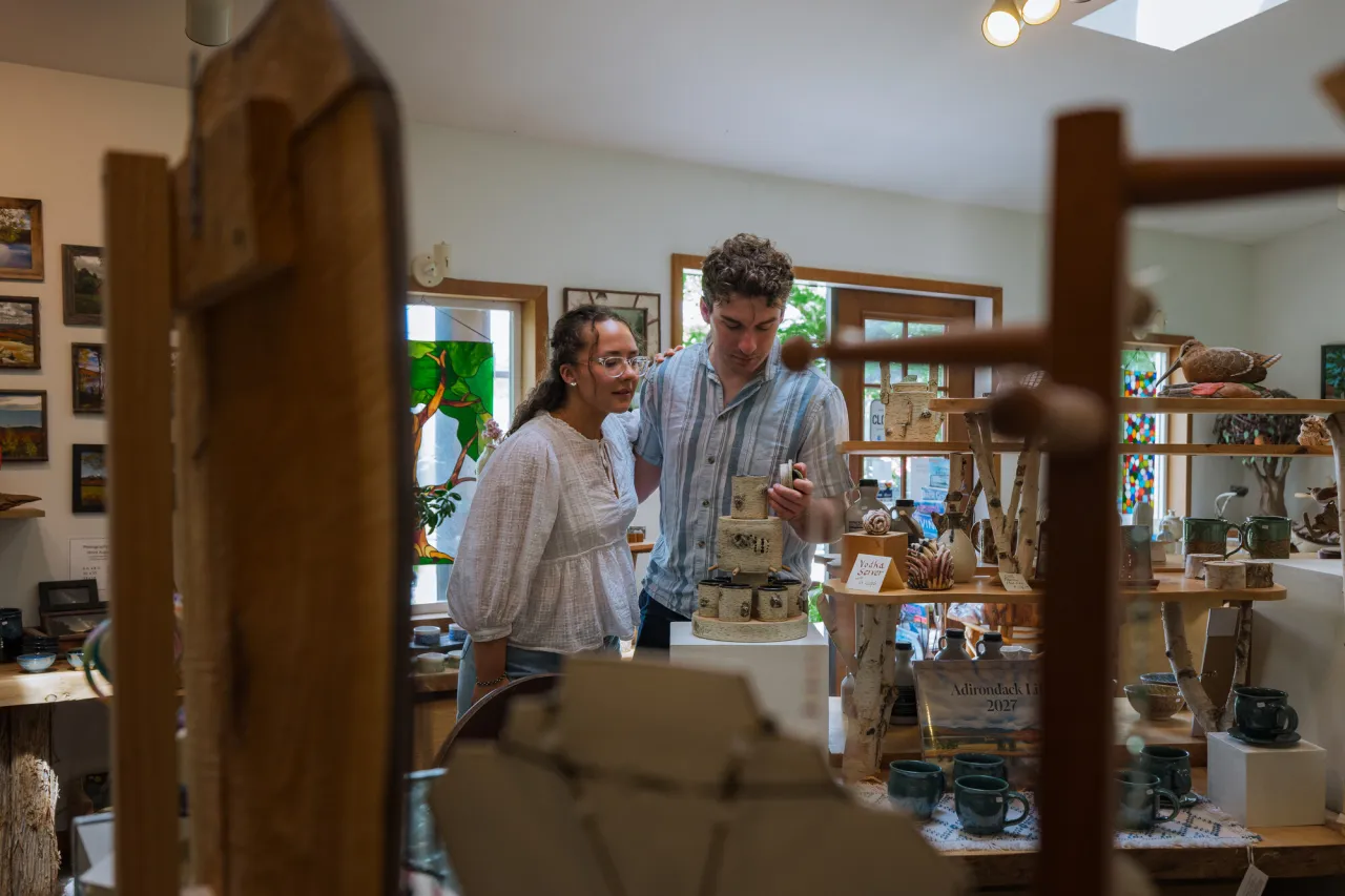 A couple walking around Young's Studio.