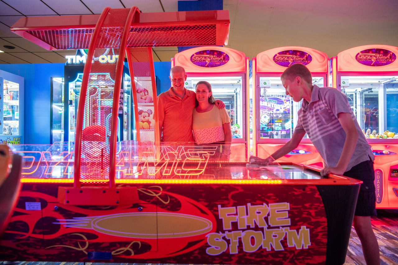 A family playing at the arcade