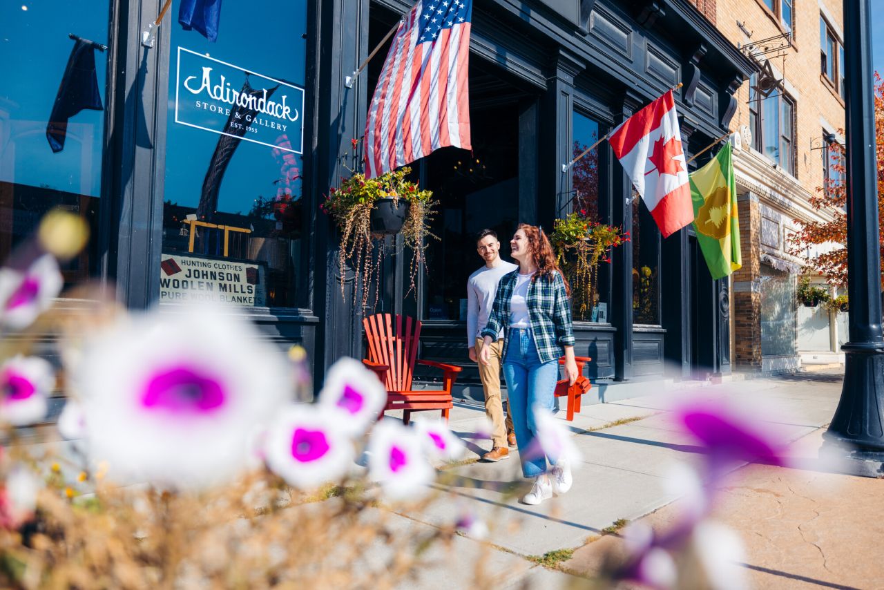 A couple walking down Park Street, Tupper Lake