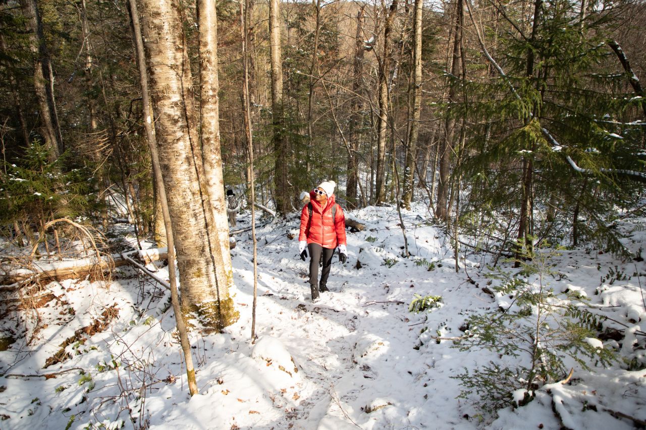 A woman hikes a winter trail.