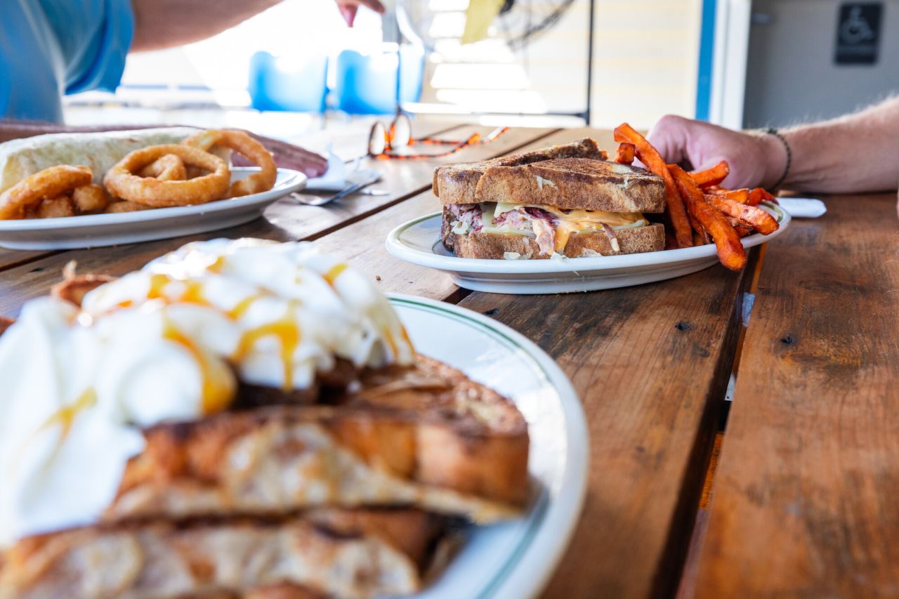 plates of sandwiches and lunch food at a diner.