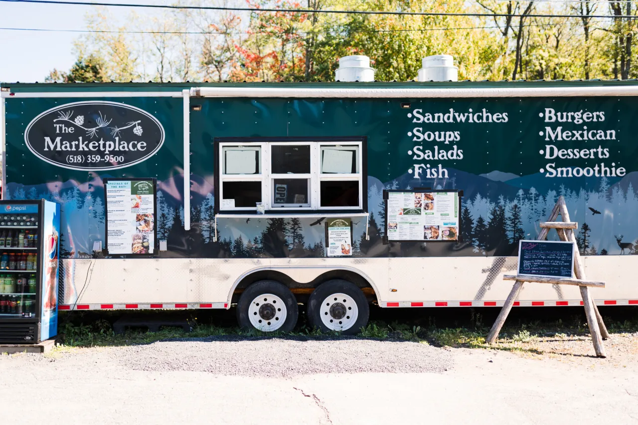 A food truck on a fall day.