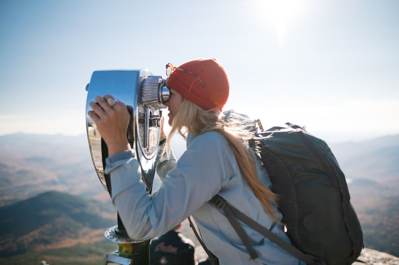 A woman sightseeing at Whiteface Mountain.