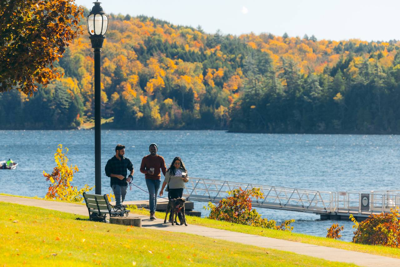 A group of people walking in Downtown Schroon Lake during fall.