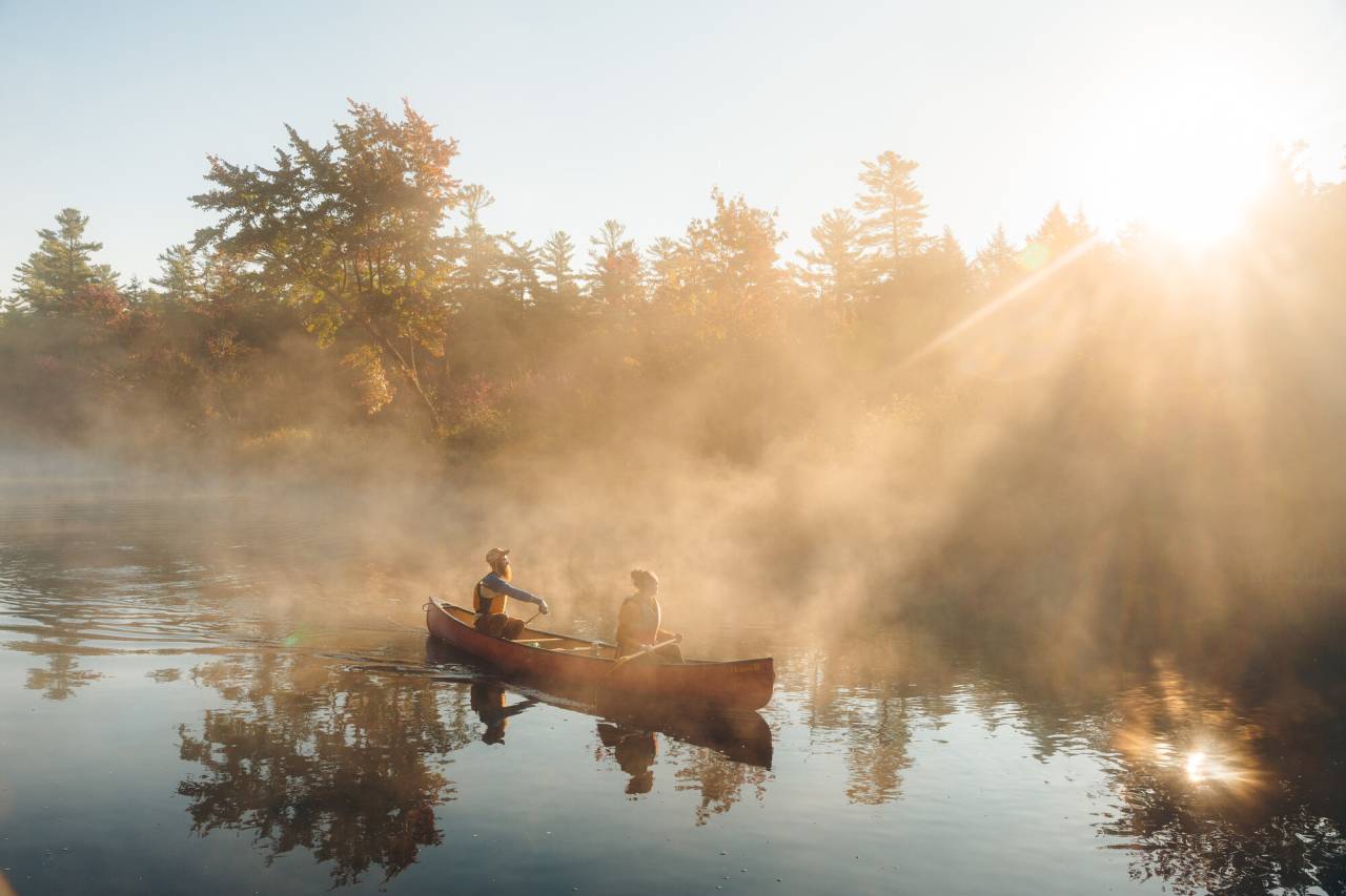 Two people paddling in Saranac Lake.