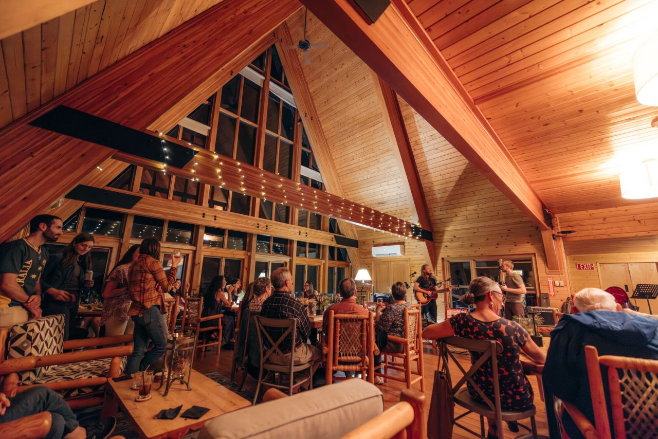 A lively bar with live music in a warm A-frame dining room. 