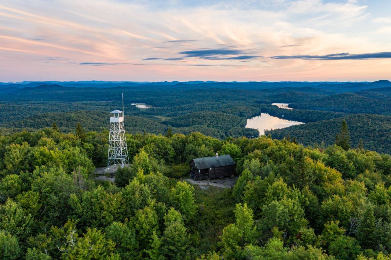 An aerial view of the summit of Mount Arab at sunset.