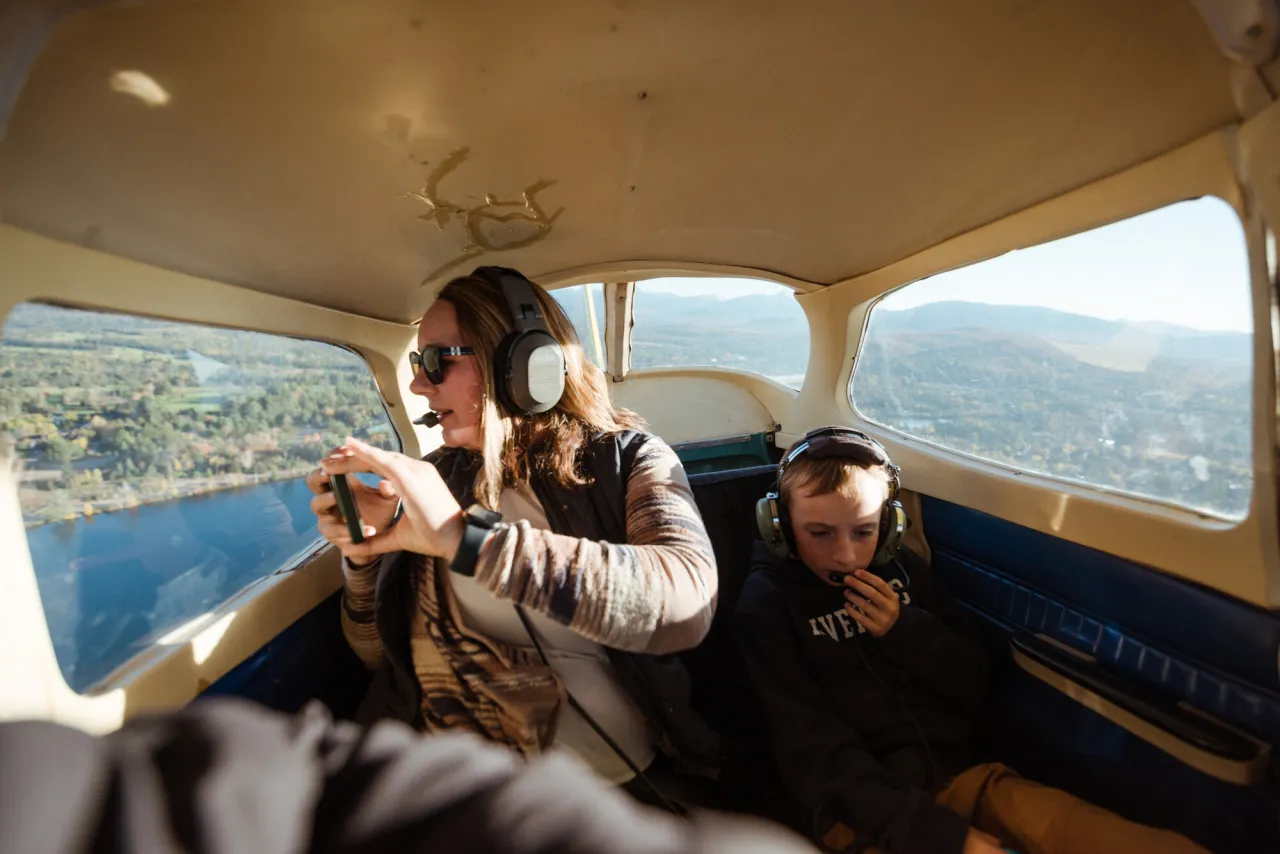 A woman and her son take a flight in a float plane ride.