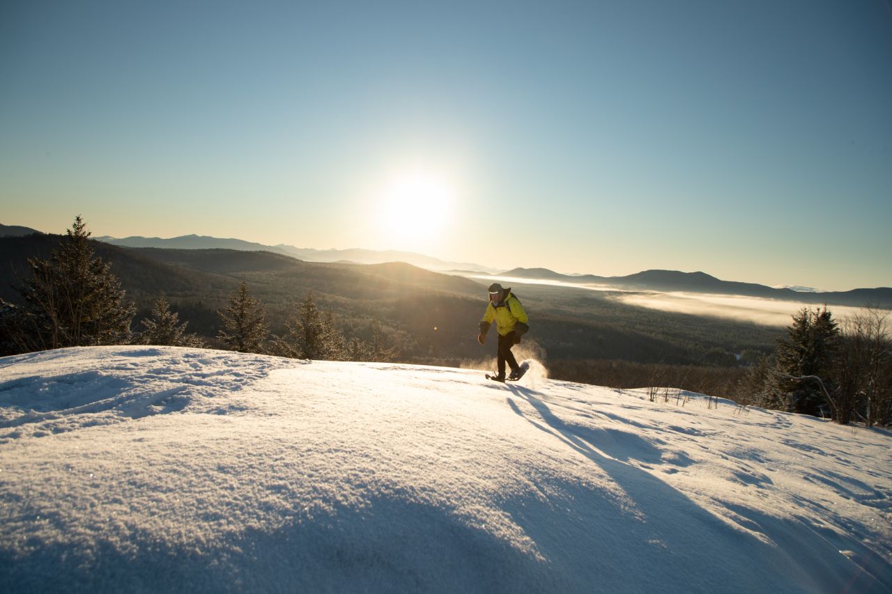 A hiker on a bare summit in the winter.
