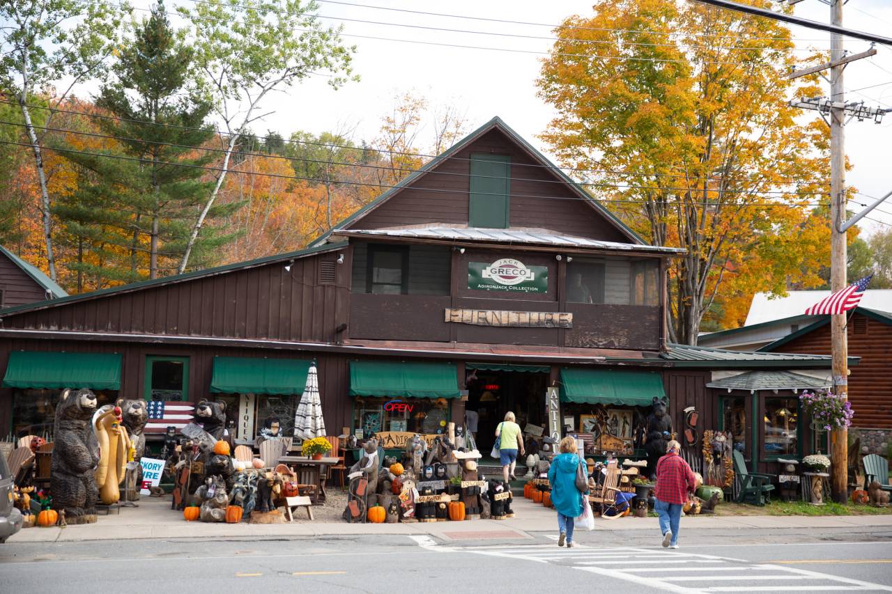 Two people walk to a country store in fall.