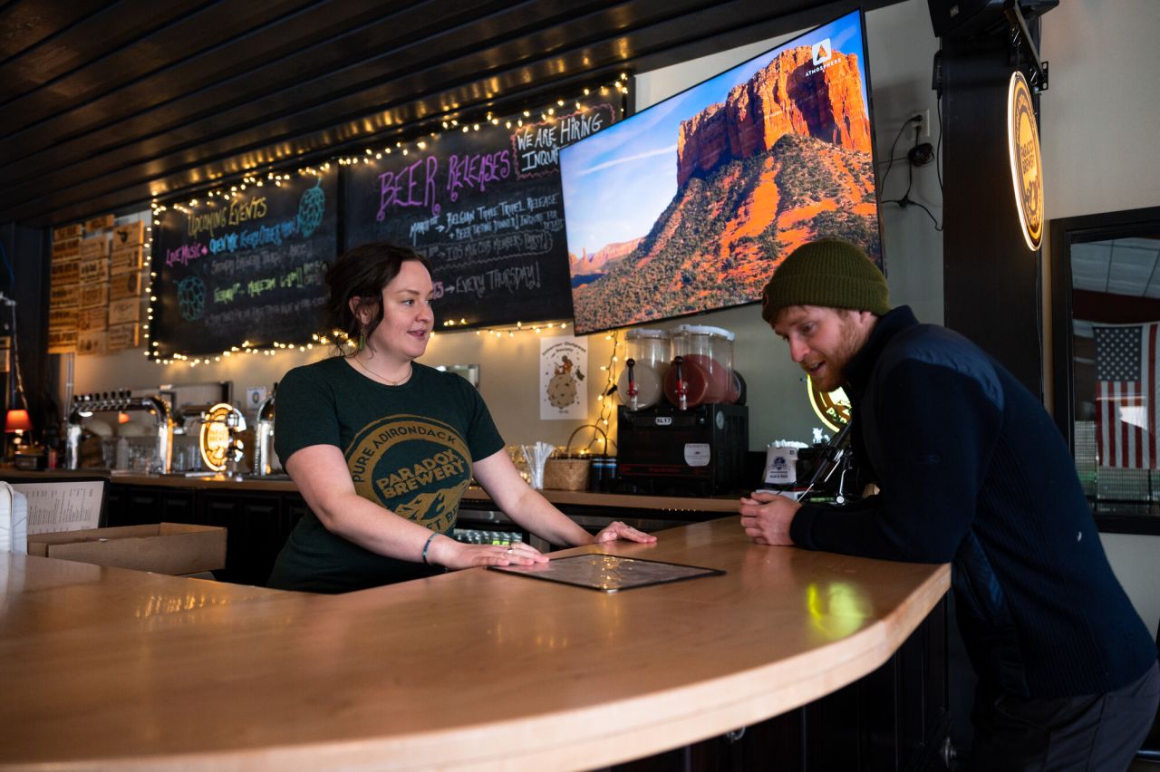 A man orders a drink at a bar.