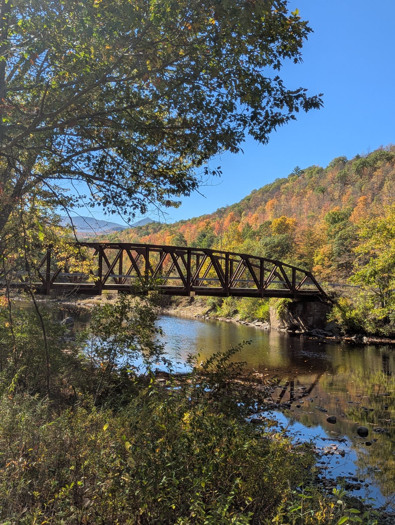 A bridge with fall foliage in the Whiteface Region.