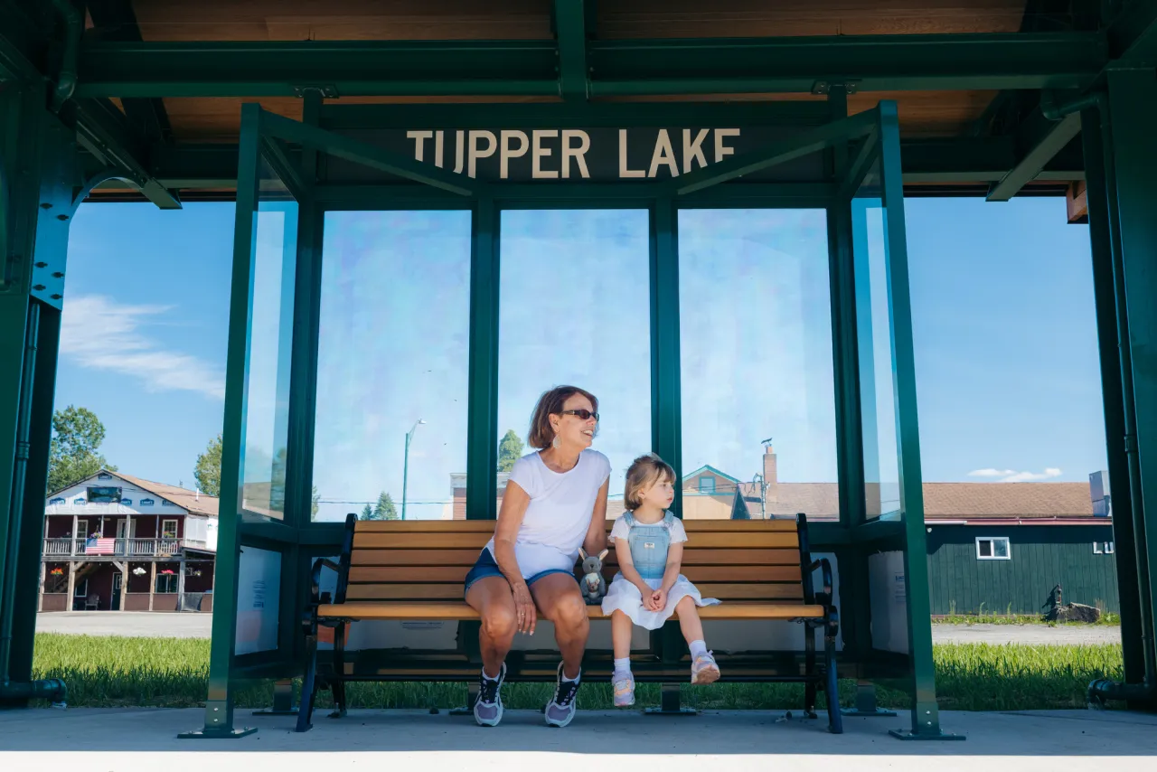 A family sitting at the train station.