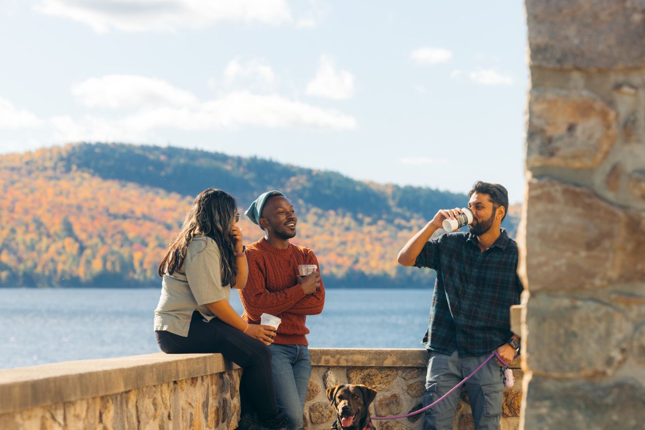 A group of people drinking Nine Mile Coffee in Schroon Lake.