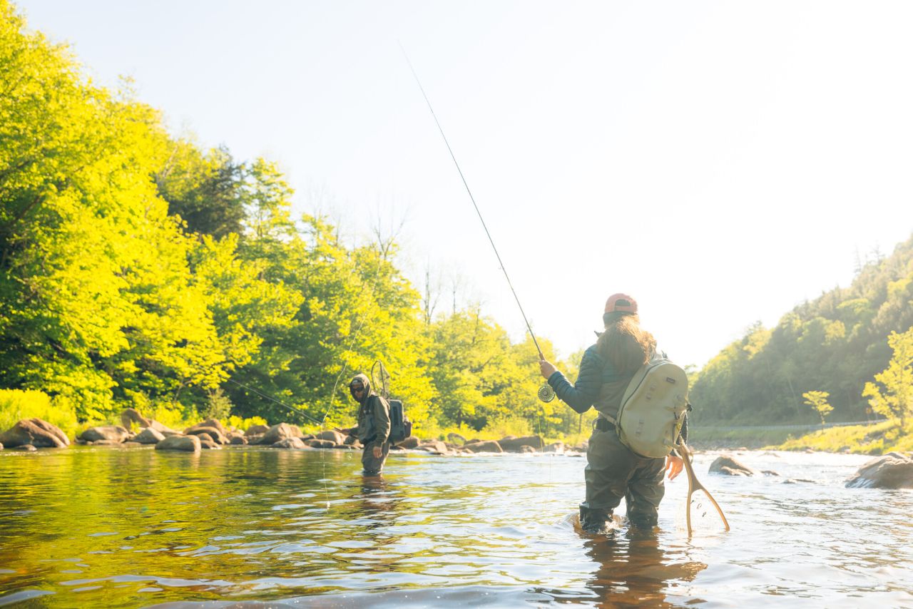 A couple fly fishing in spring.