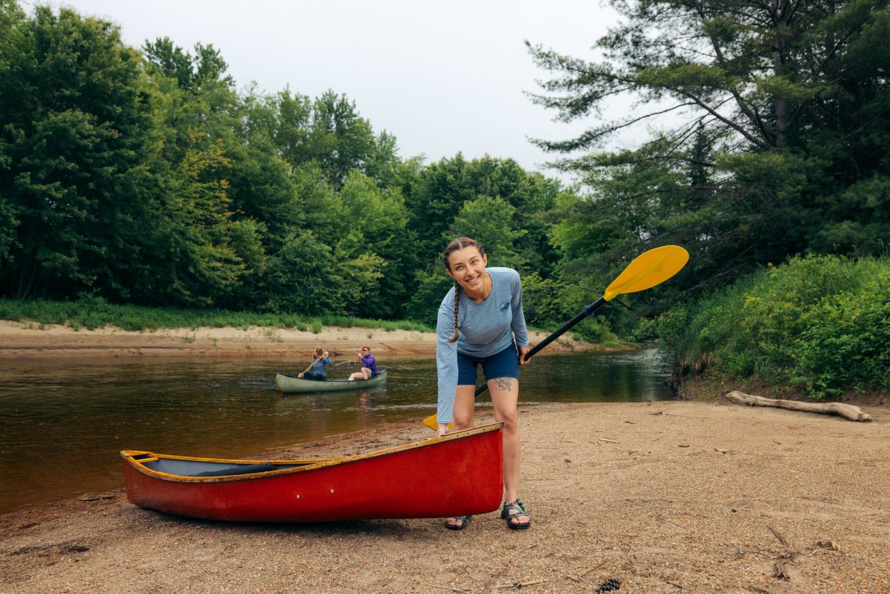 A woman putting in her canoe in the Adirondack Hub.