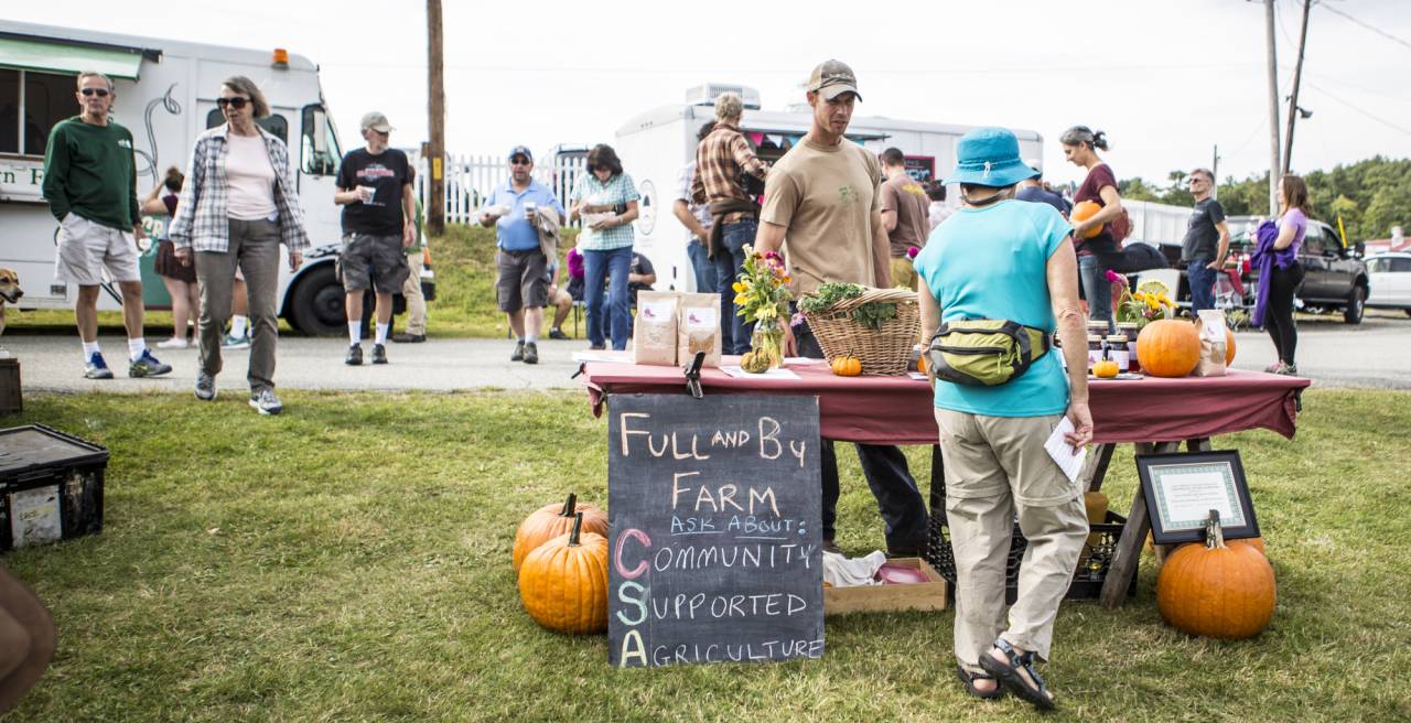 A vendor selling produce at the Adirondack Harvest Festival.
