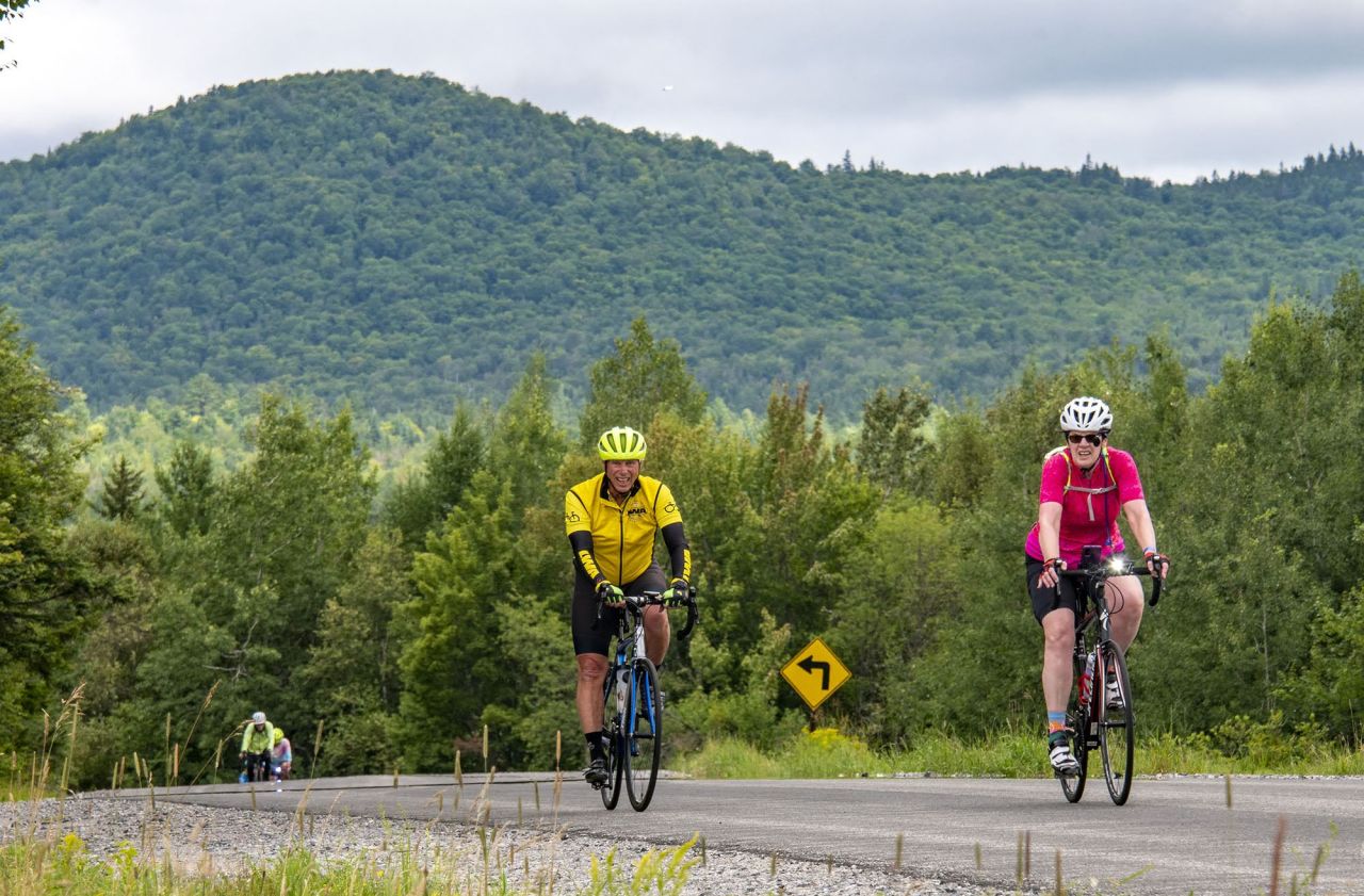 Two bikers riding in Saranac Lake.