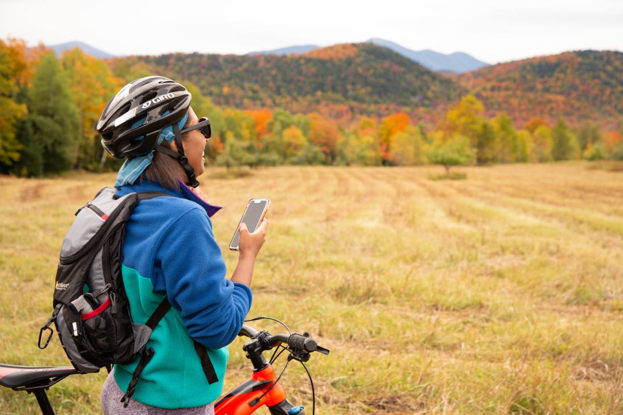 A person on their bike with fall scenery.
