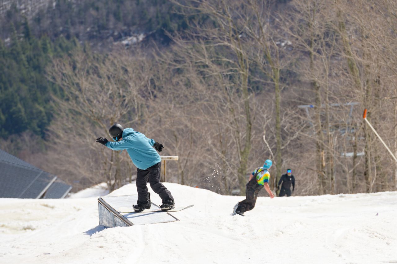 Snowboarders at the Whiteface Mountain terrain park.