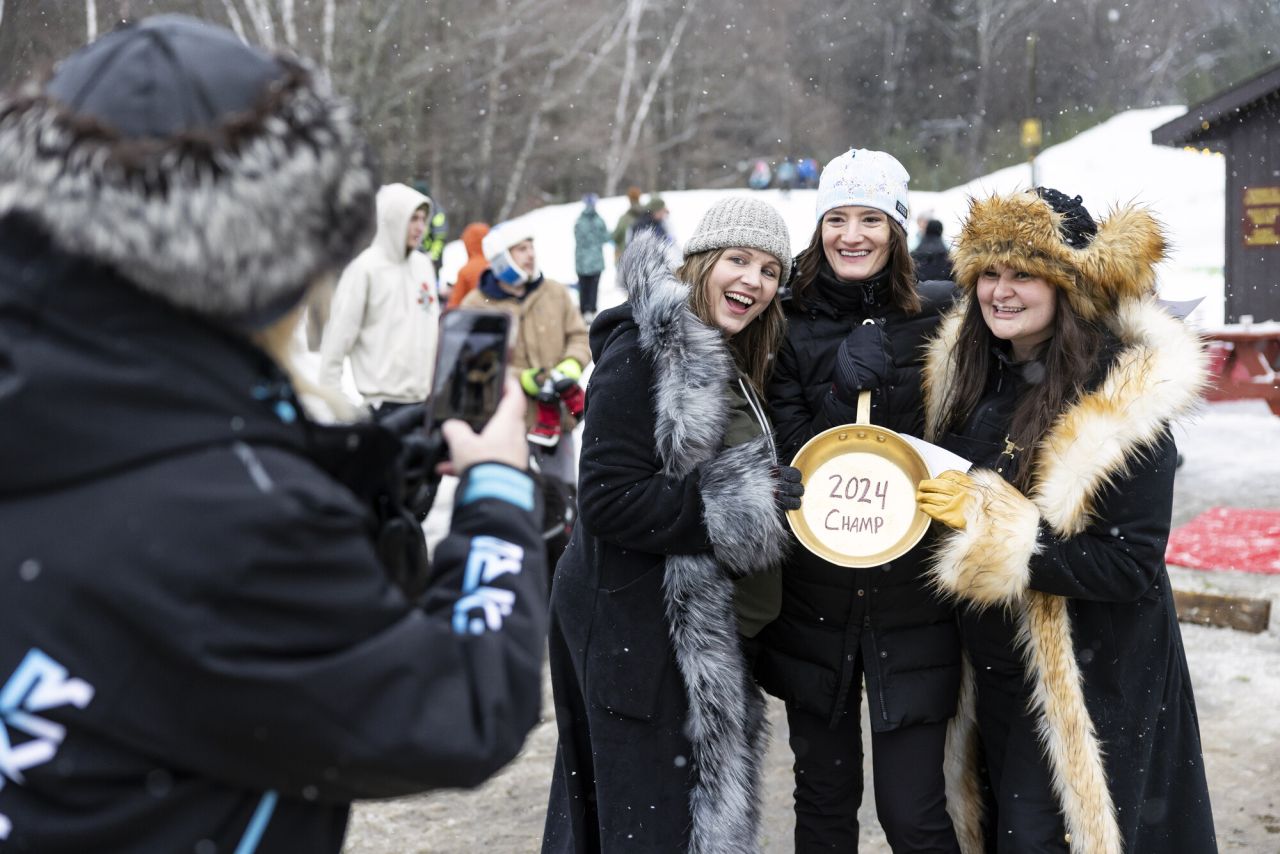 A group of women posing for a photo at a winter event.