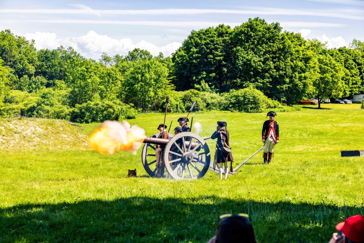 military men shooting a cannon