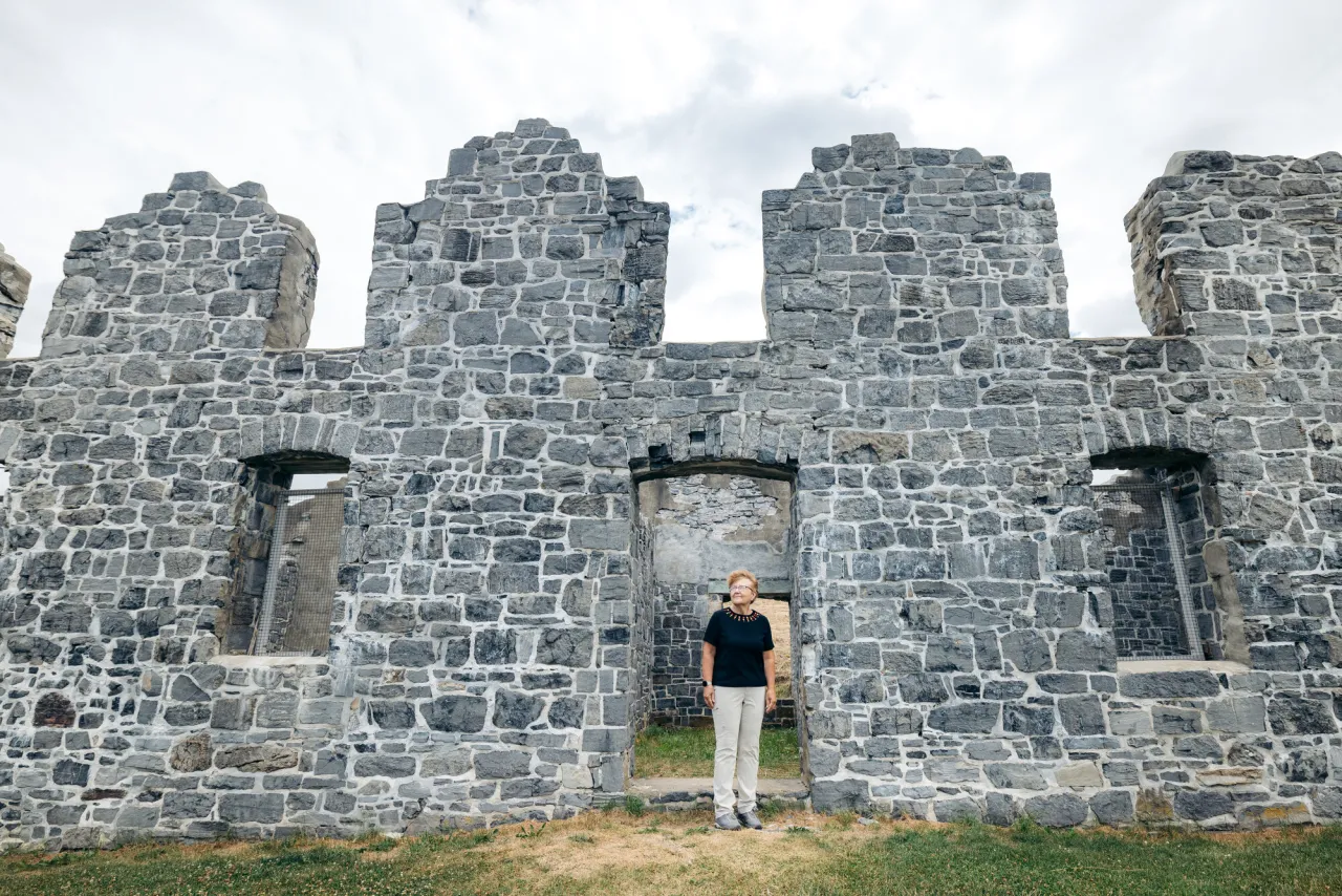 A woman standing in front of the Crown Point Historic Site.