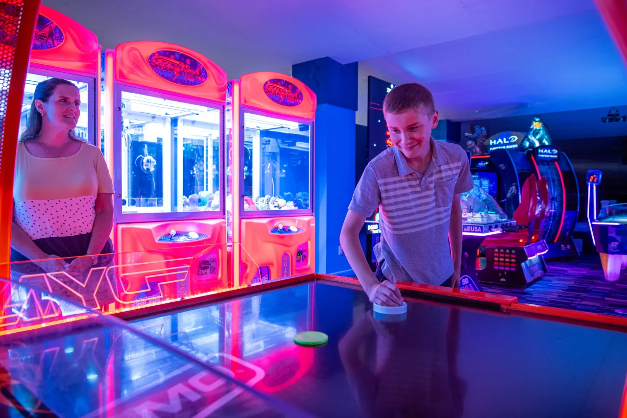 a child playing an arcade game