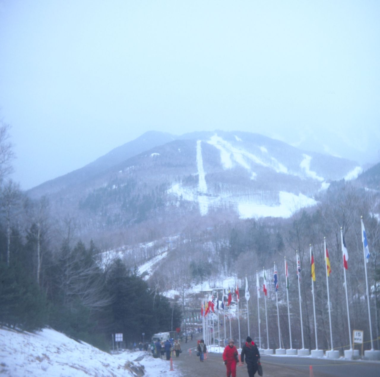A square camera image looking towards a snowy, cloud-topped Whiteface Mountain, taken during the 1980 Olympic Winter Games.