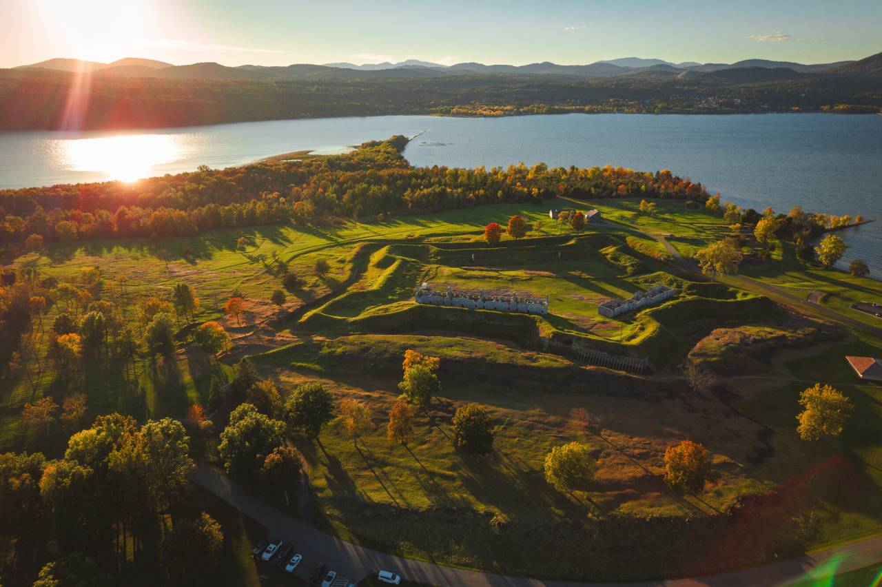 A star-shaped fort in fall along a waterfront. 