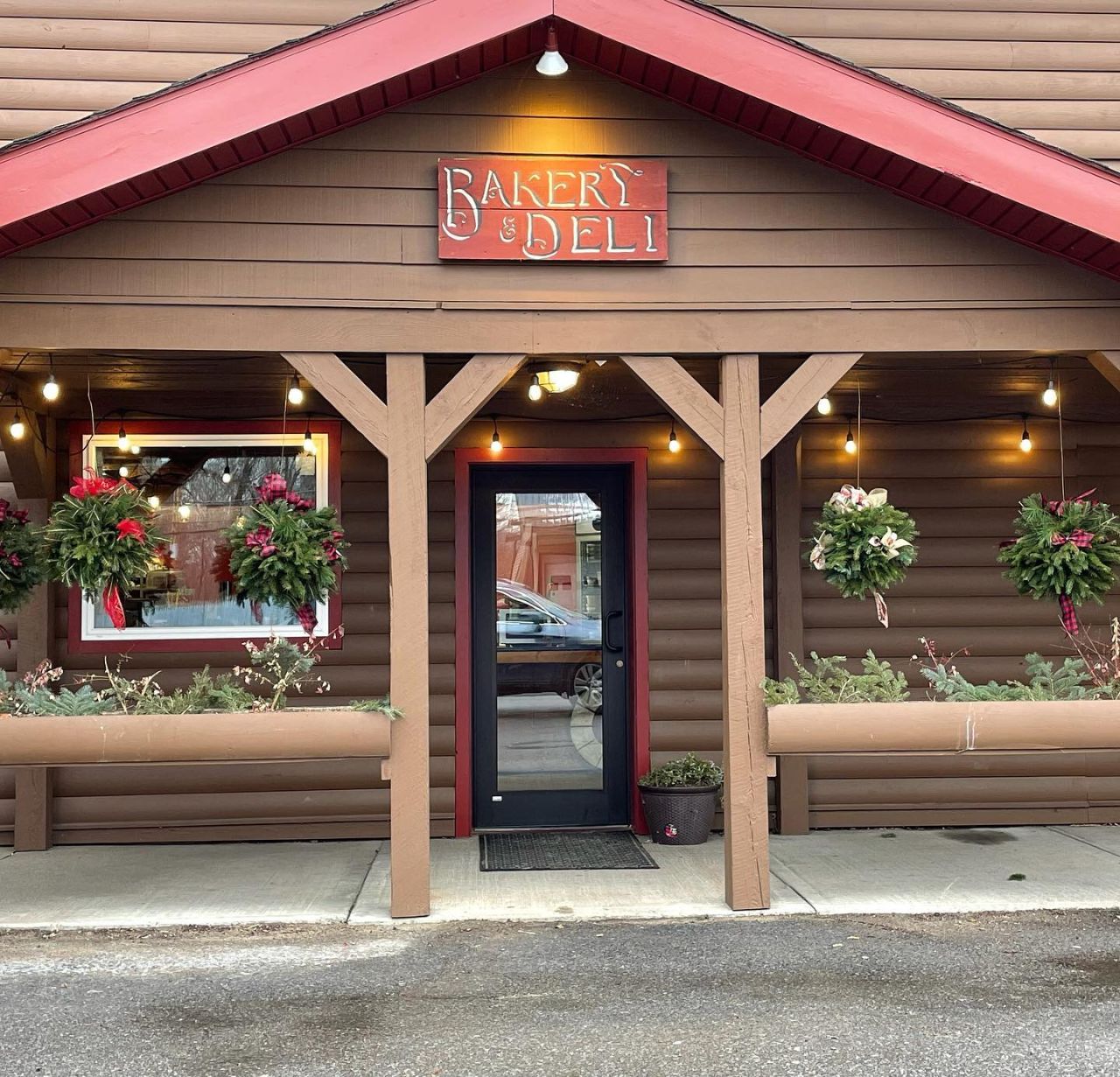 A rustic lodge-style entryway to a gas station bakery and deli.