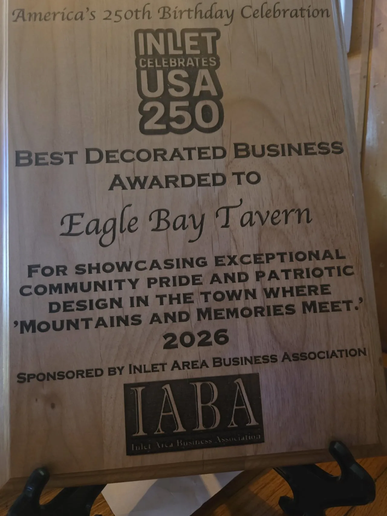 Close-up of a wooden award plaque, awarding best decorating to the Eagle Bay Tavern in Inlet, NY.
