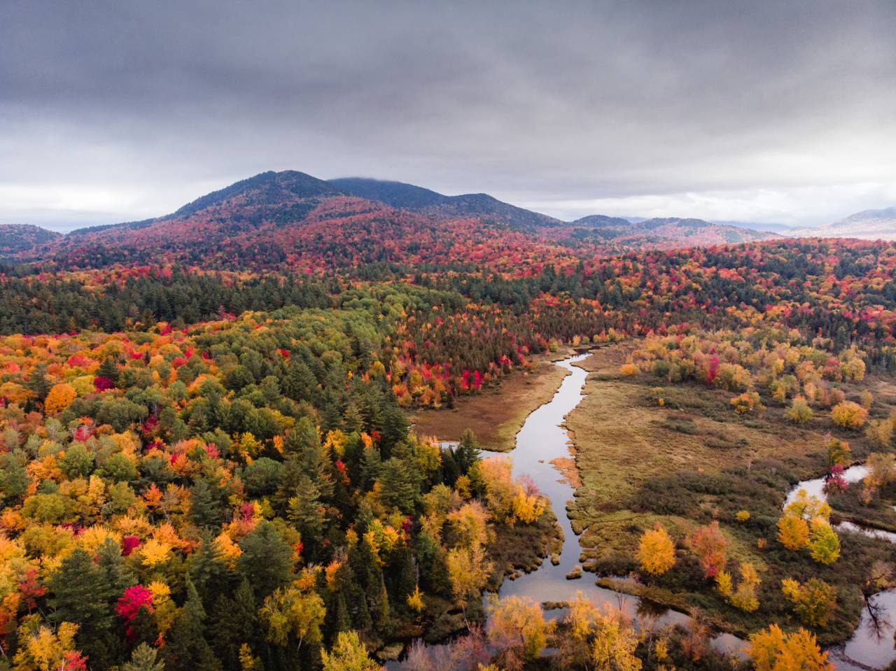 The Osgood River with fall foliage and mountain views.