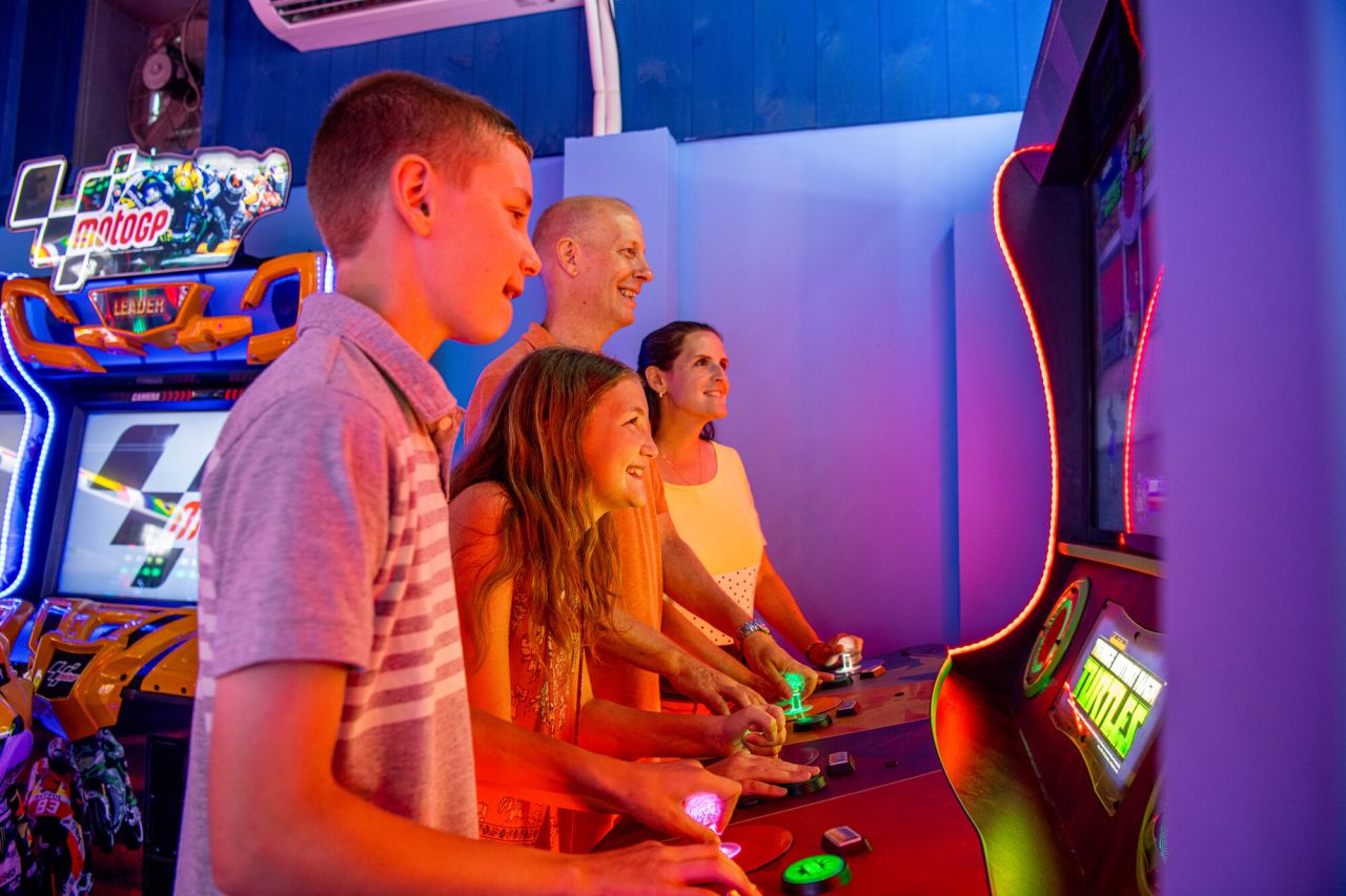 A family playing in an arcade