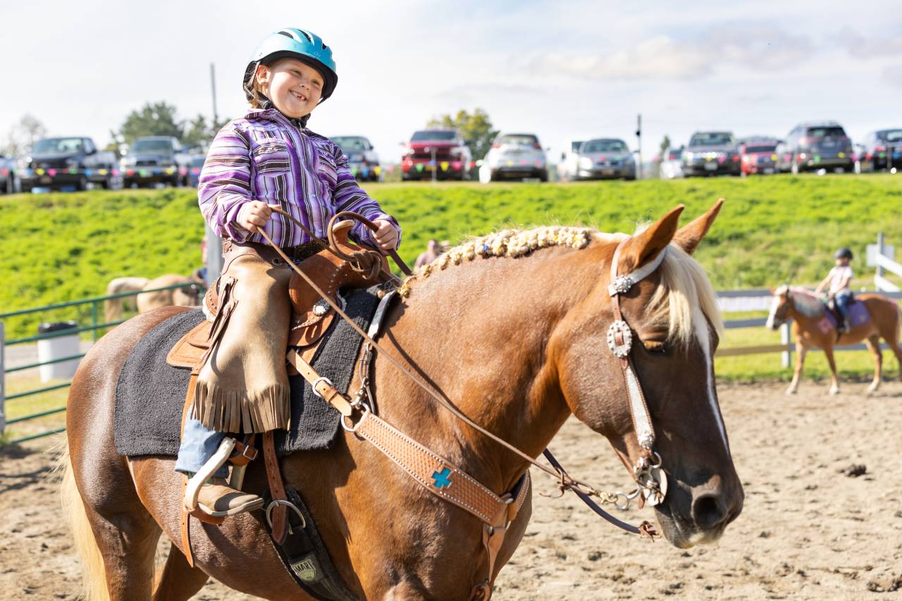 A child riding a horse at the Adirondack Harvest Festival.