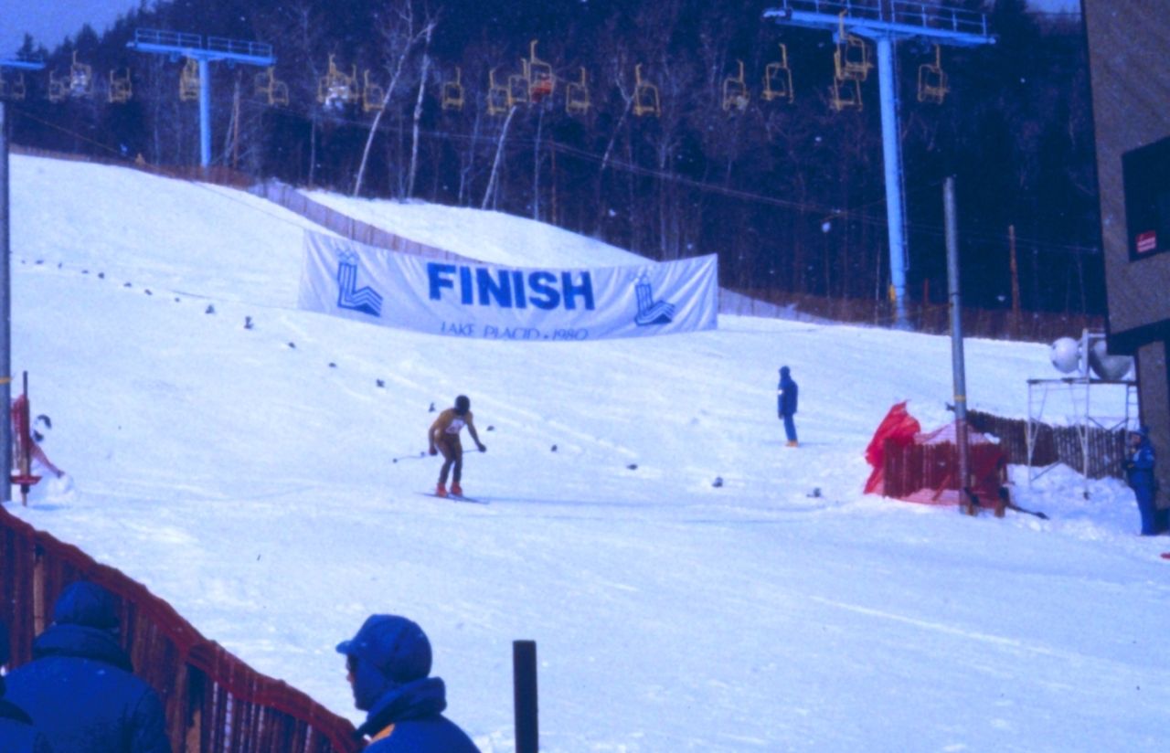A skier crosses the finish line at an Alpine skiing event at the 1980 Winter Olympics at Whiteface Mountain.
