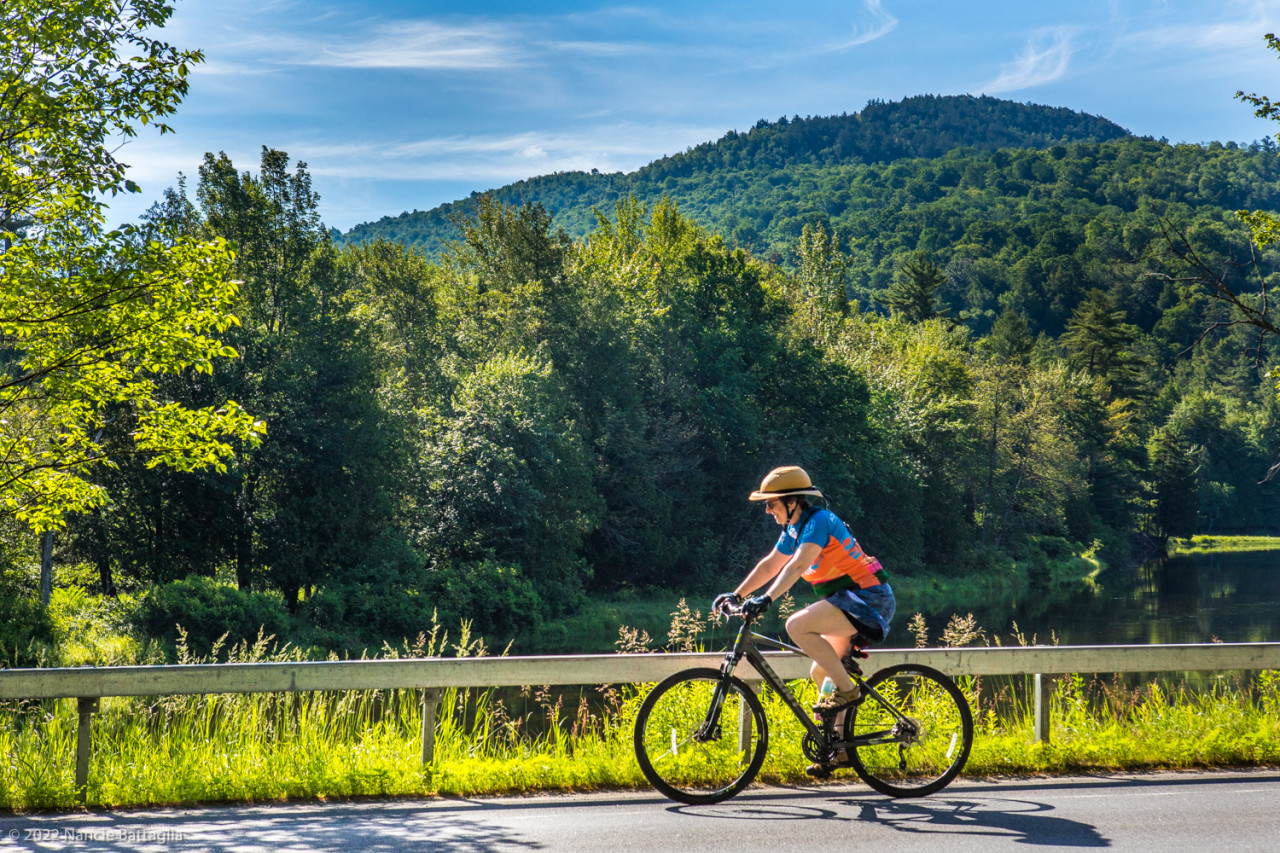 A biker riding along a scenic road.