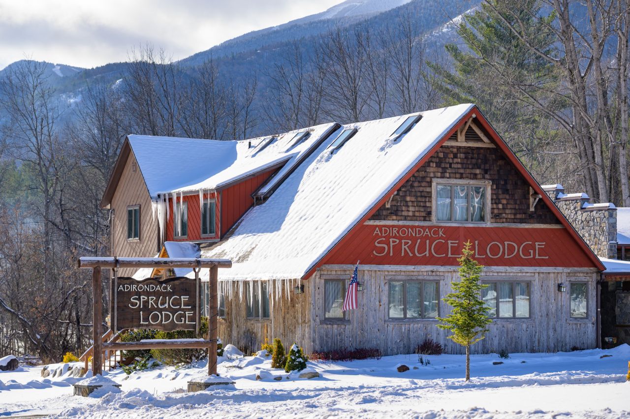 A lodge in winter covered in snow. 