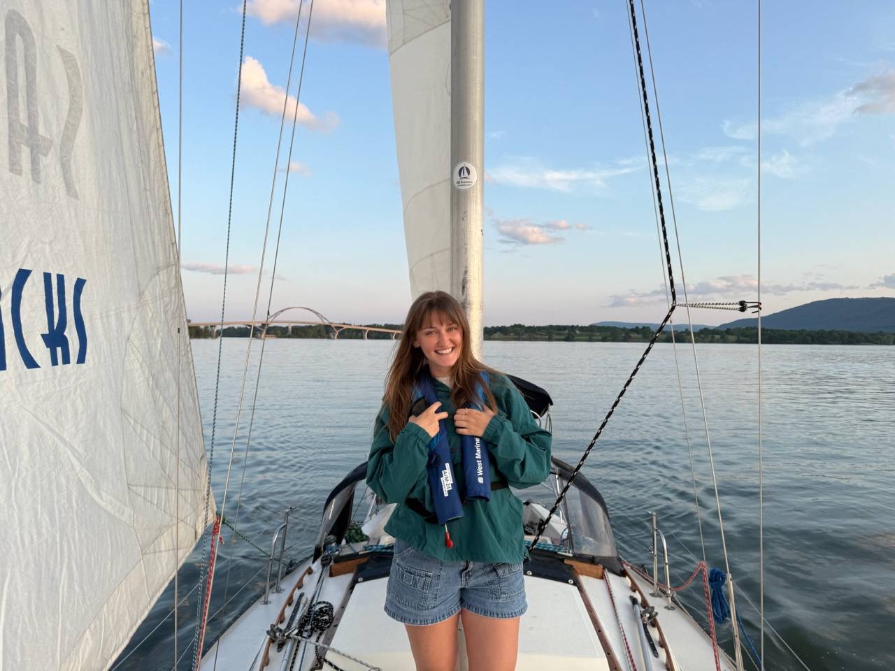 Krissy Navrat posing for a photo on a Sail Adirondacks sunset cruise.