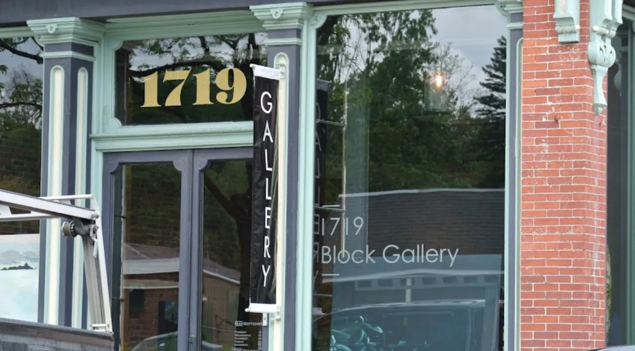 the outside of a vintage gallery in a small town.