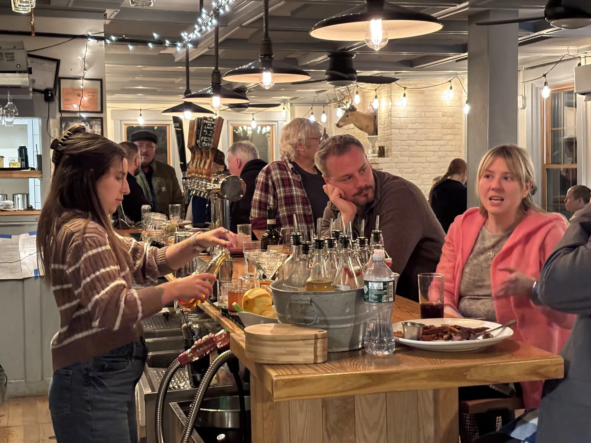 bartender making drinks behind the bar