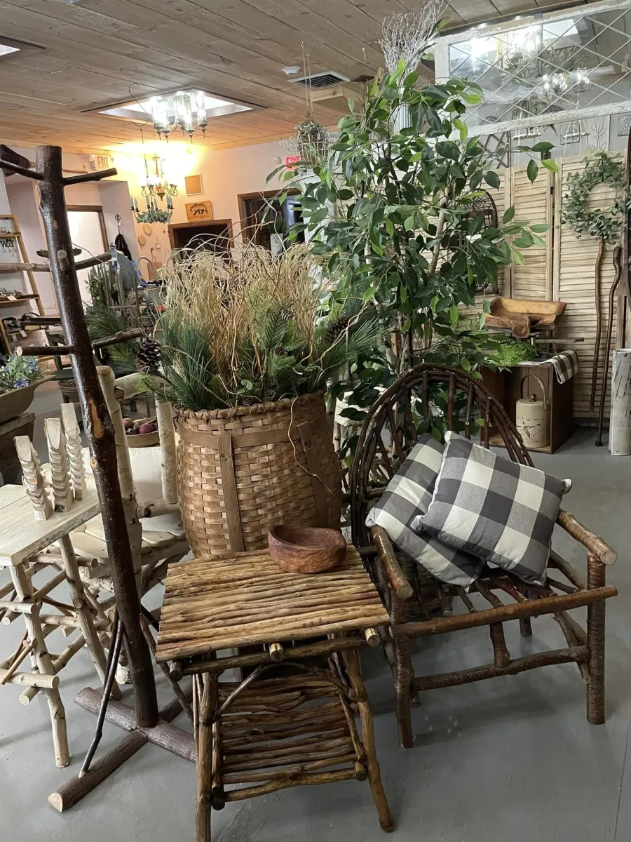 Woven twig chairs, tables and pack baskets stuffed with greenery