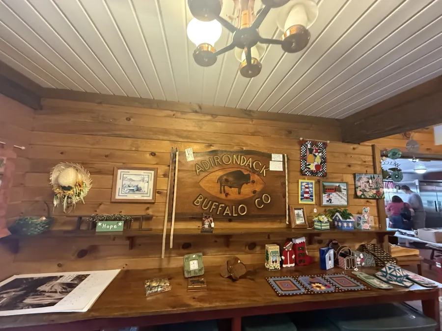 Entry sign for the Adirondack Buffalo Company with various merchandise for sale surrounding it