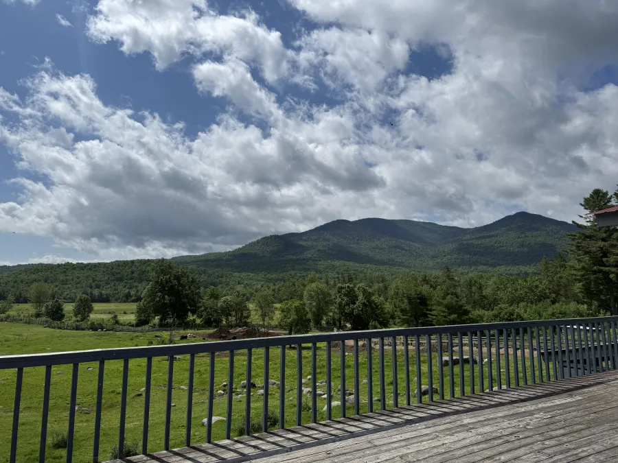 A view of the mountains and puffy clouds that surround the buffalo pastures