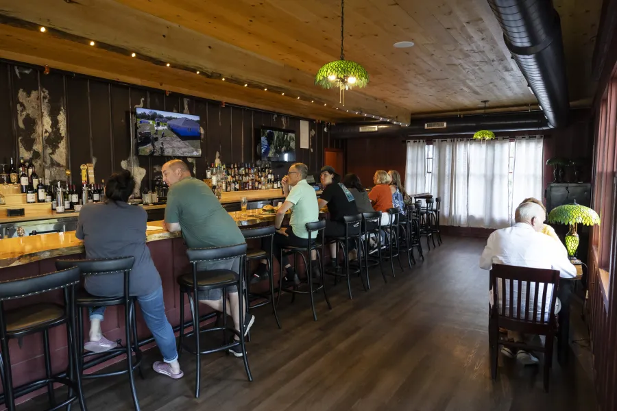 The classic bar area with dark woods and dimmed lighting