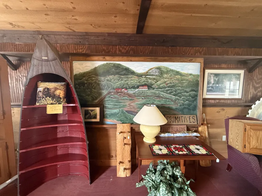 A large painting of the buffalo pasture with the buildings looking down over them.